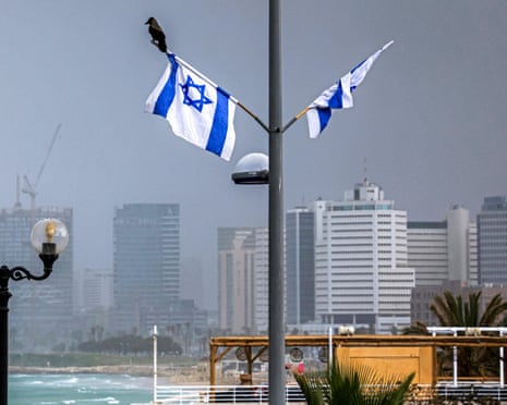 Minh họa về con quạ đậu trên lá cờ Israel gần bờ biển Tel Aviv